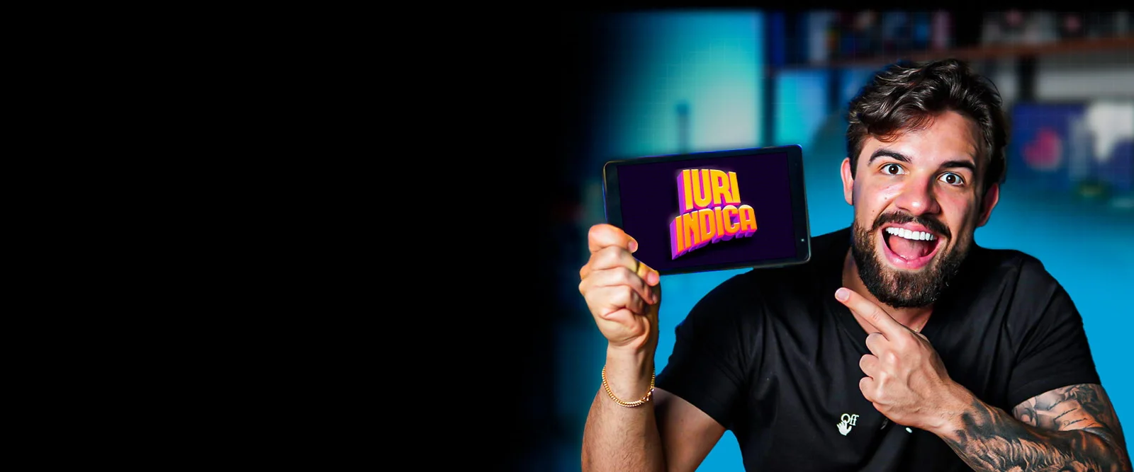 Iuri sorrindo e mostrando um tablet com a marca Iuri Indica